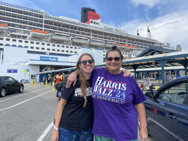 me standing next to my mom smiling in front of the boat